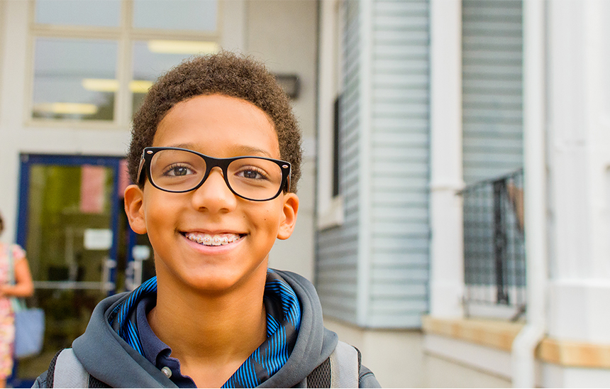 Child with glasses smiling